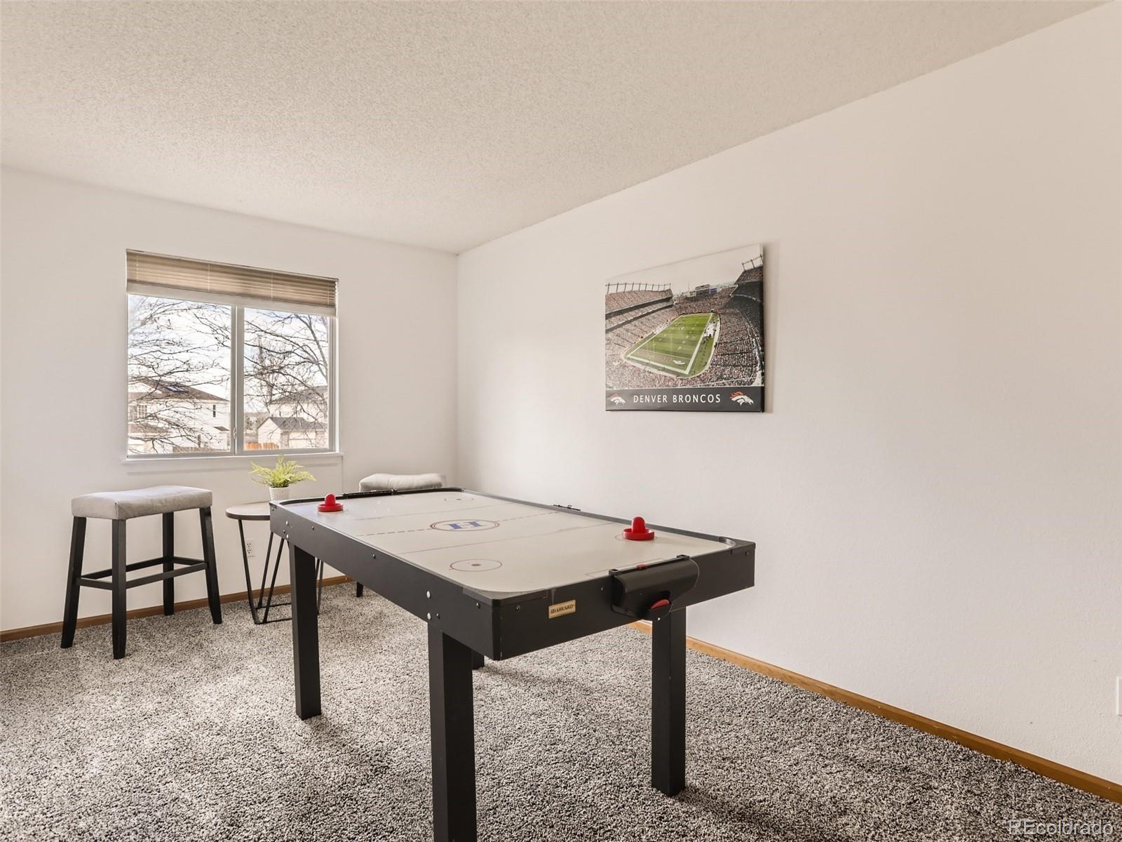 4399 Perth Circle Denver, CO 80249 - Photo 25 of 30 a view of a room that has a table and chairs in it
