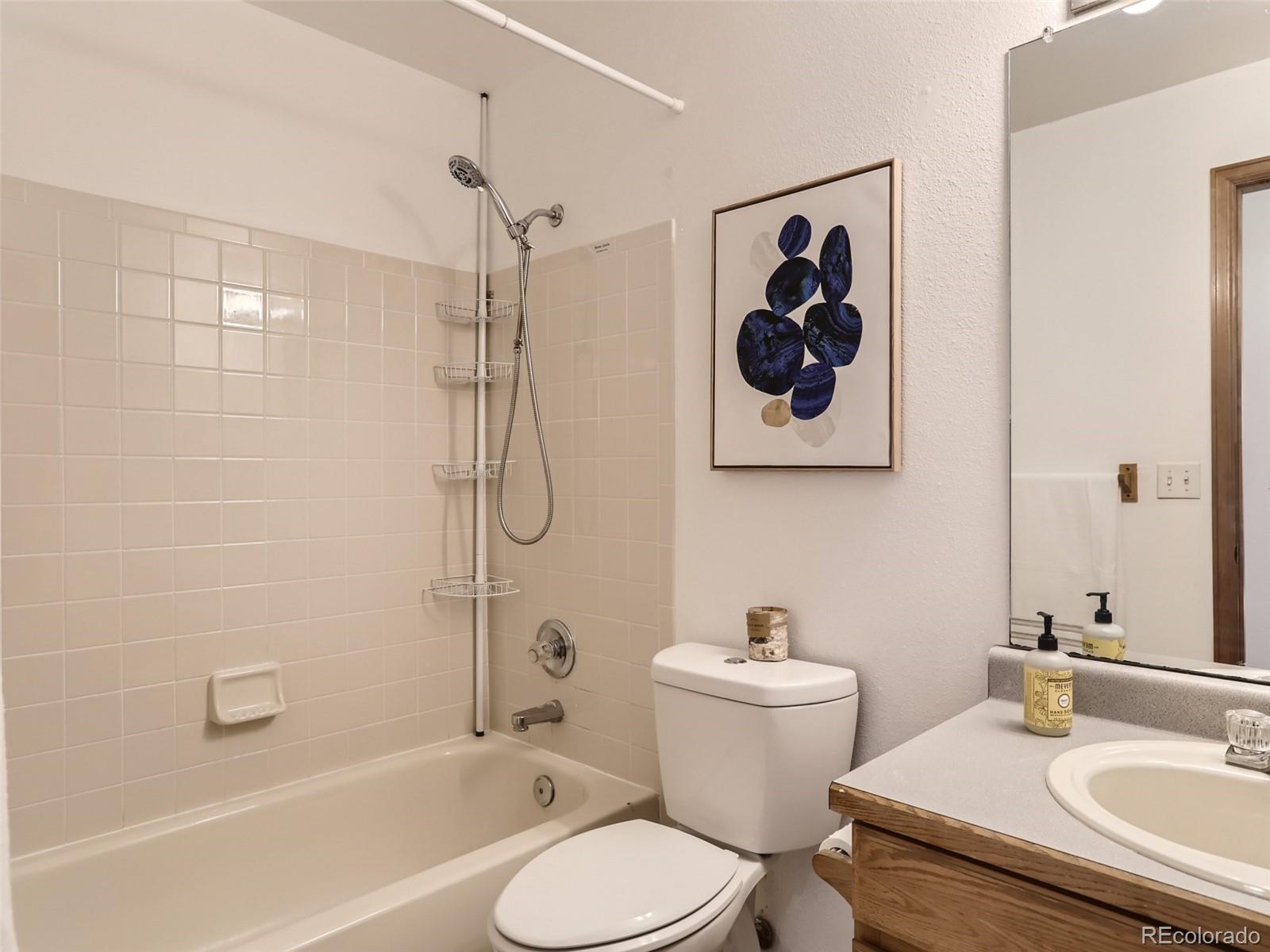 4399 Perth Circle Denver, CO 80249 - Photo 26 of 30 a bathroom with a sink toilet and shower