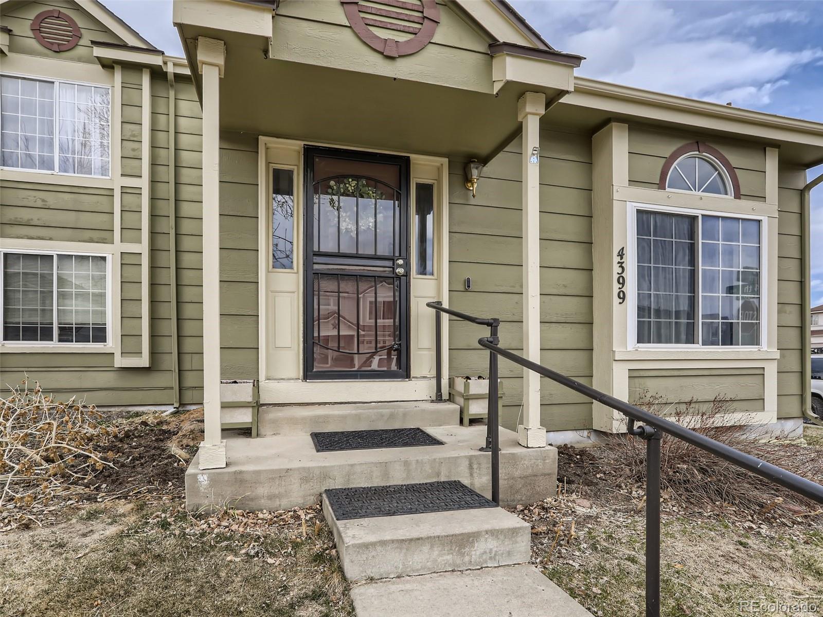 4399 Perth Circle Denver, CO 80249 - Photo 3 of 30 a front view of a house with a yard