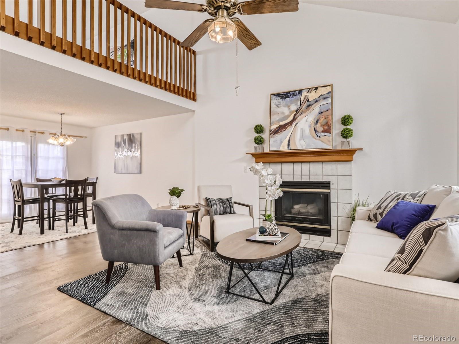 4399 Perth Circle Denver, CO 80249 - Photo 7 of 30 a living room with furniture a rug and a fireplace