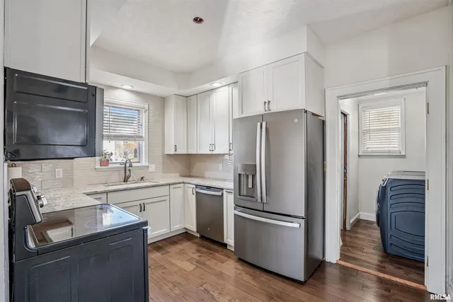 a kitchen with a refrigerator sink and microwave