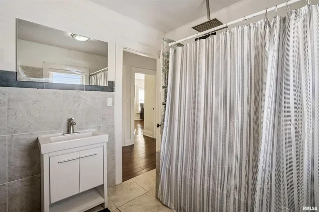 a bathroom with a sink a mirror and a shower