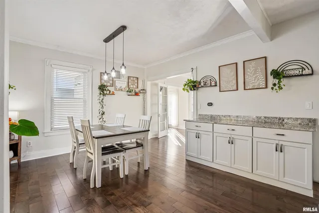 a kitchen with granite countertop center island wooden floor and stainless steel appliances
