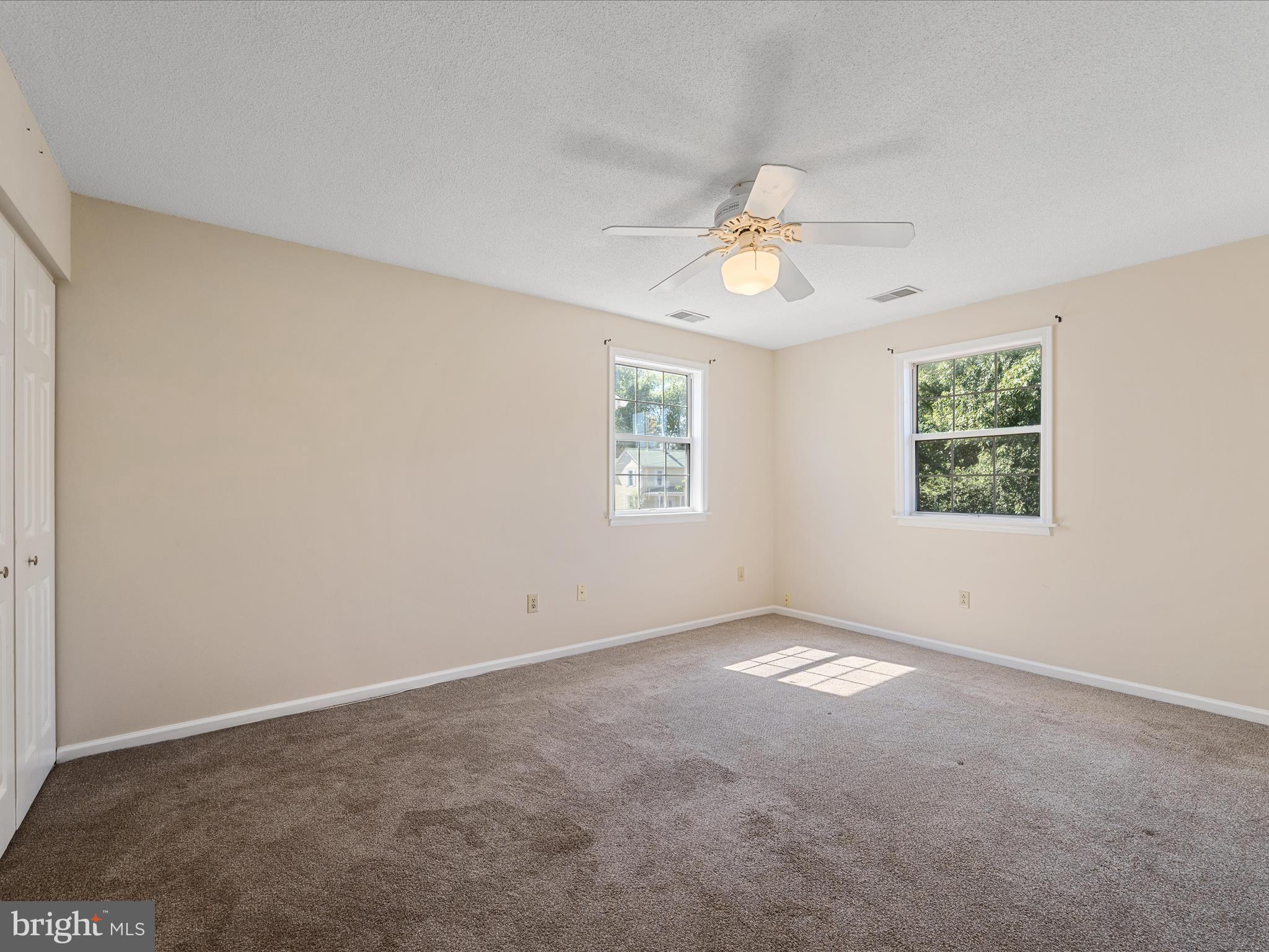 208 South Marshall Street Ranson, WV 25438 - Photo 16 of 28 an empty room with windows and ceiling fan