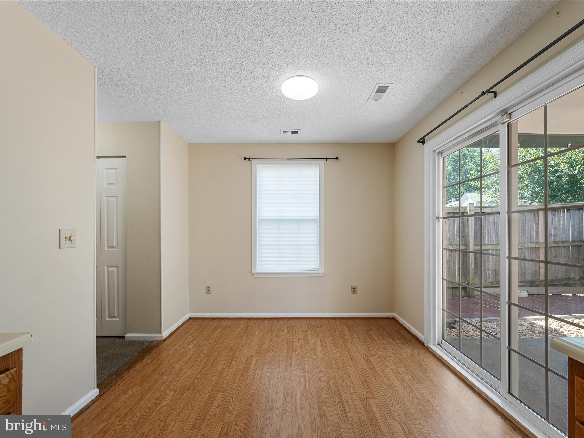 208 South Marshall Street Ranson, WV 25438 - Photo 7 of 28 wooden floor in an empty room with a window