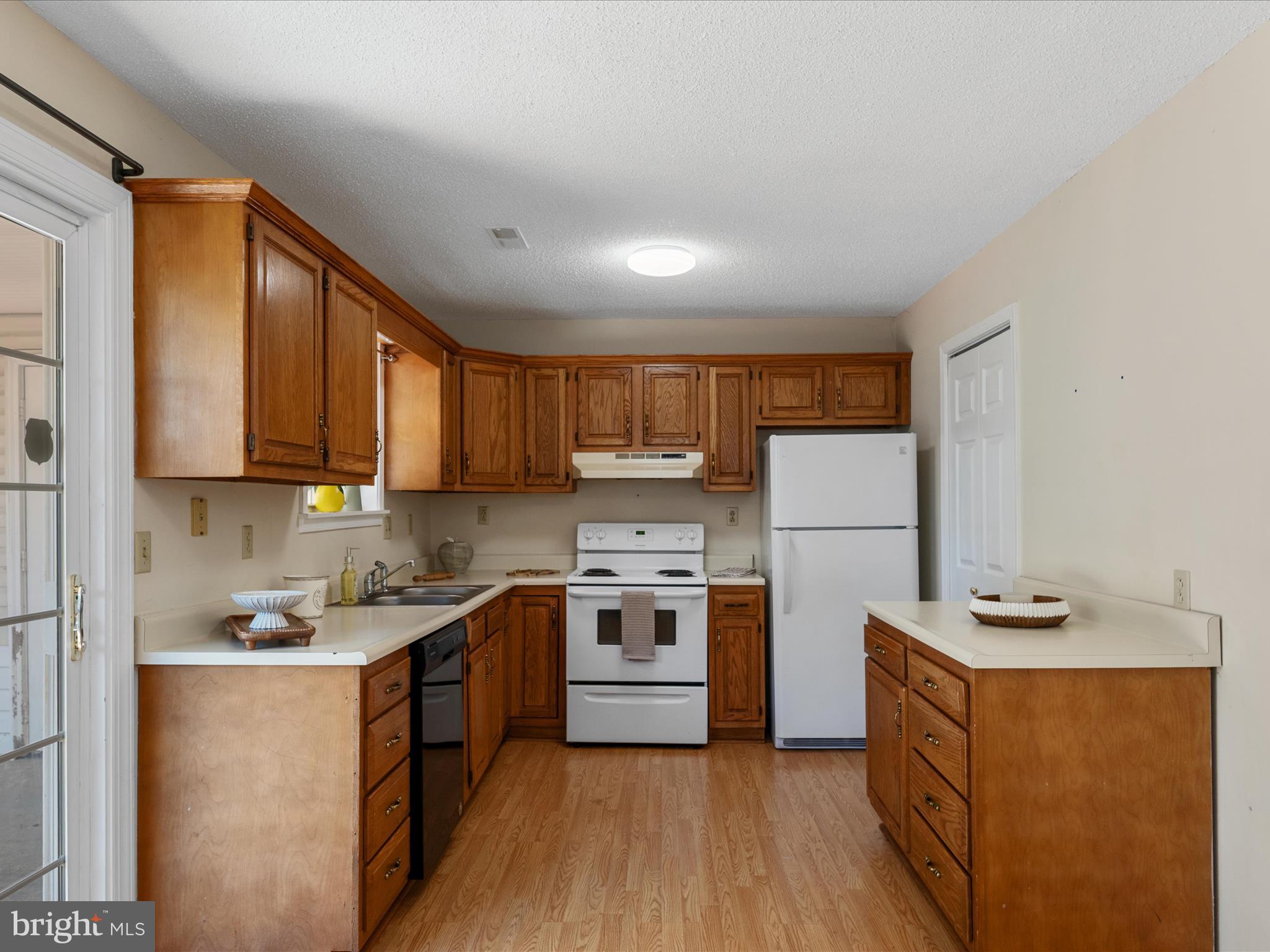208 South Marshall Street Ranson, WV 25438 - Photo 8 of 28 a kitchen with stainless steel appliances granite countertop a stove a sink dishwasher a refrigerator and white cabinets with wooden floor