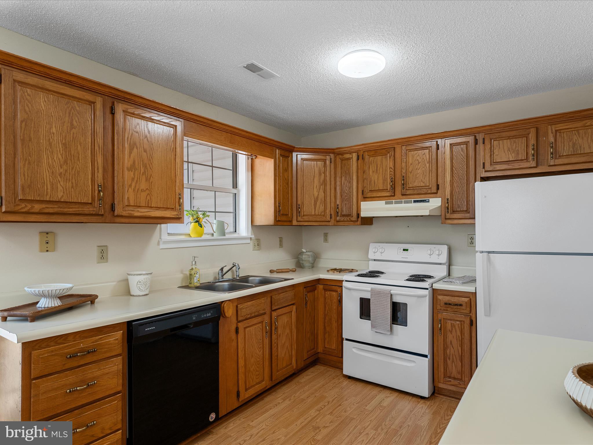 208 South Marshall Street Ranson, WV 25438 - Photo 9 of 28 a kitchen with a white stove top oven sink and cabinets