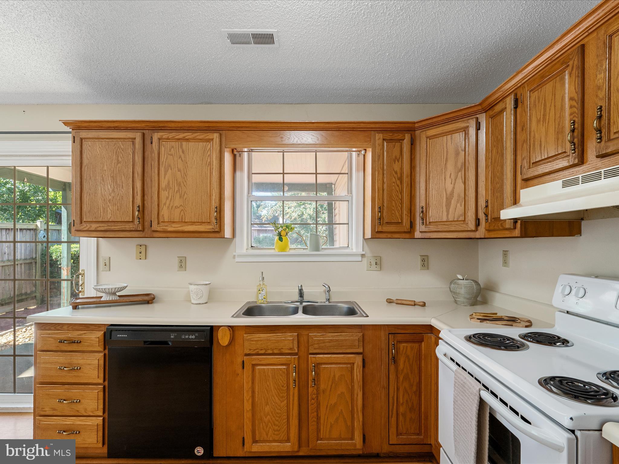 208 South Marshall Street Ranson, WV 25438 - Photo 10 of 28 a kitchen with granite countertop wooden cabinets and white appliances