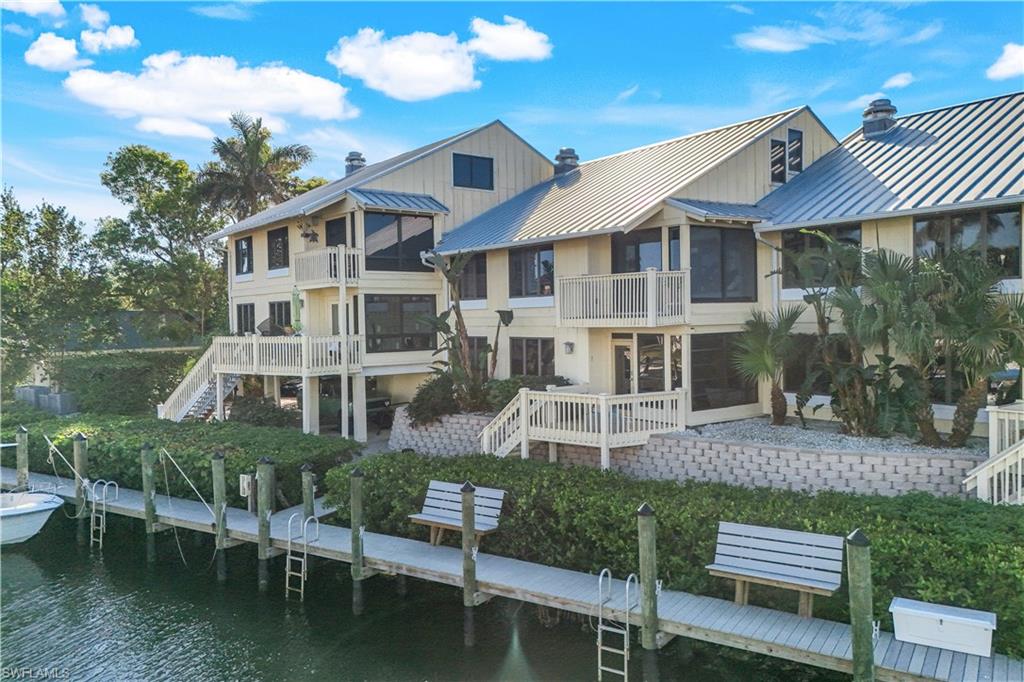 1323 Chesapeake Avenue, Unit 1B Naples, FL 34102 - Photo 17 of 17 a front view of a house with a yard