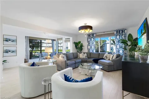a living room with fireplace furniture and a large window