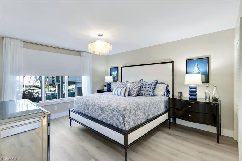 1323 Chesapeake Avenue, Unit 1B Naples, FL 34102 - Photo 5 of 17 a spacious bedroom with a bed and a large window