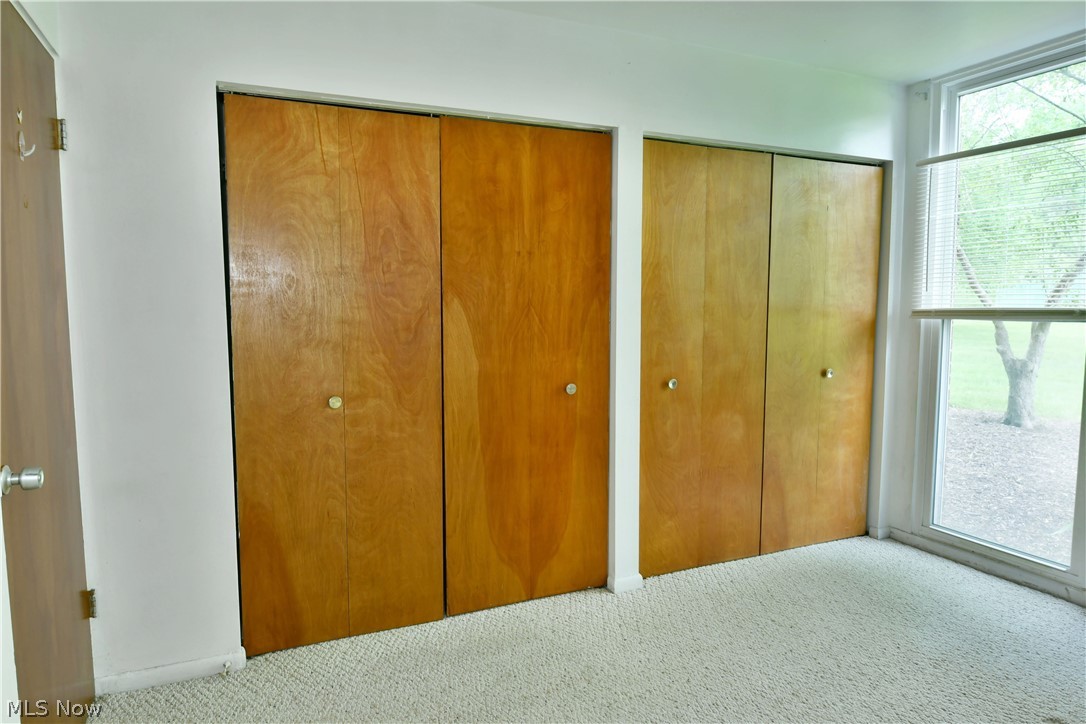 3020 North River Road Northeast, Unit G2 Warren, OH 44483 - Photo 19 of 29 Unfurnished bedroom featuring multiple closets and carpet floors