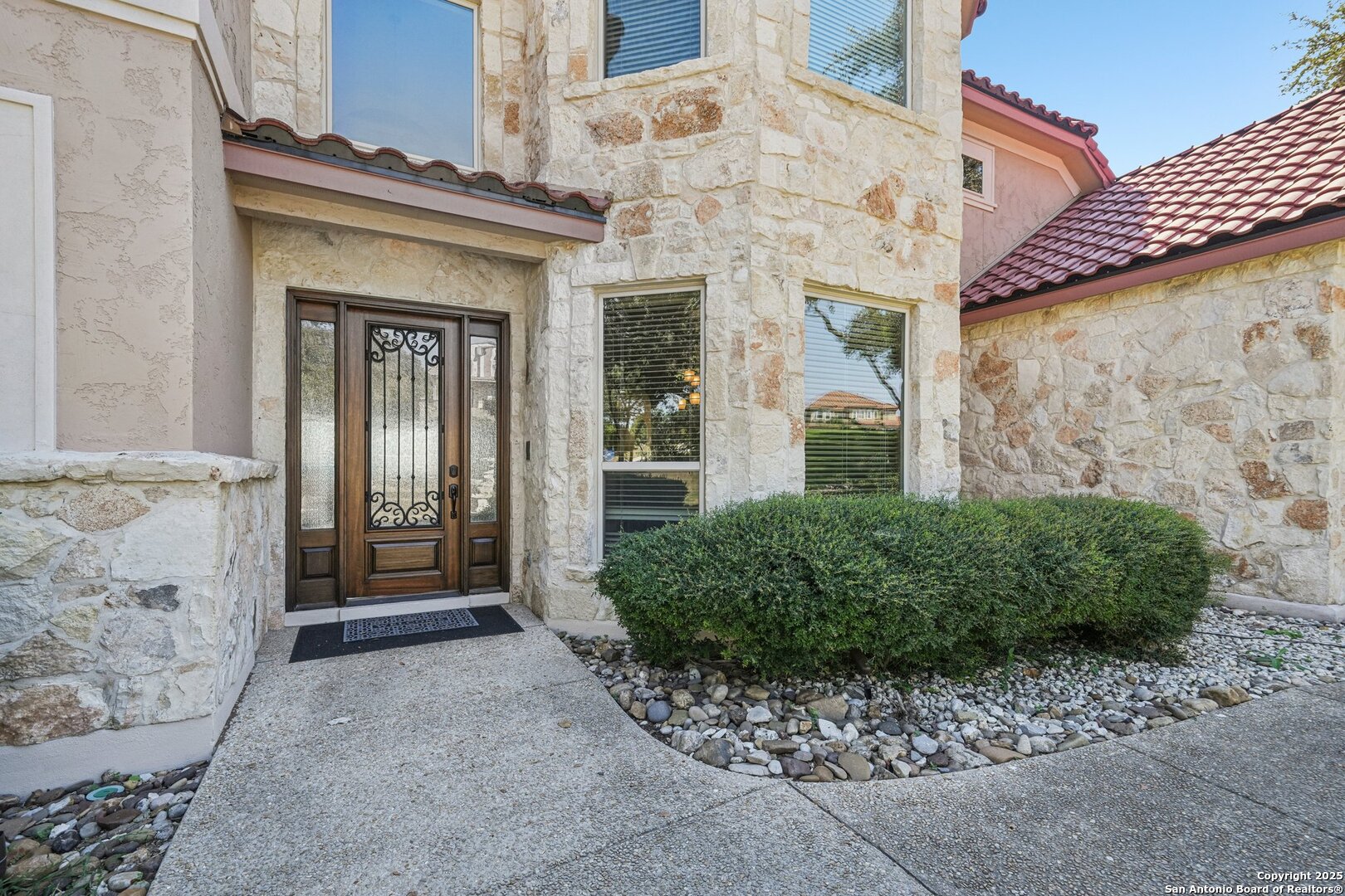 718 Ruidosa Downs Helotes, TX 78023 - Photo 45 of 50 a view of a brick house with potted plants