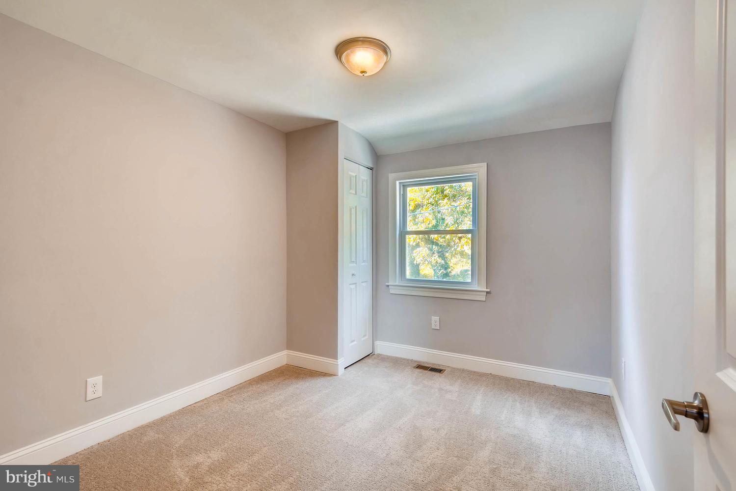 3834 Rexmere Road Baltimore, MD 21218 - Photo 18 of 28 an empty room with windows and closet