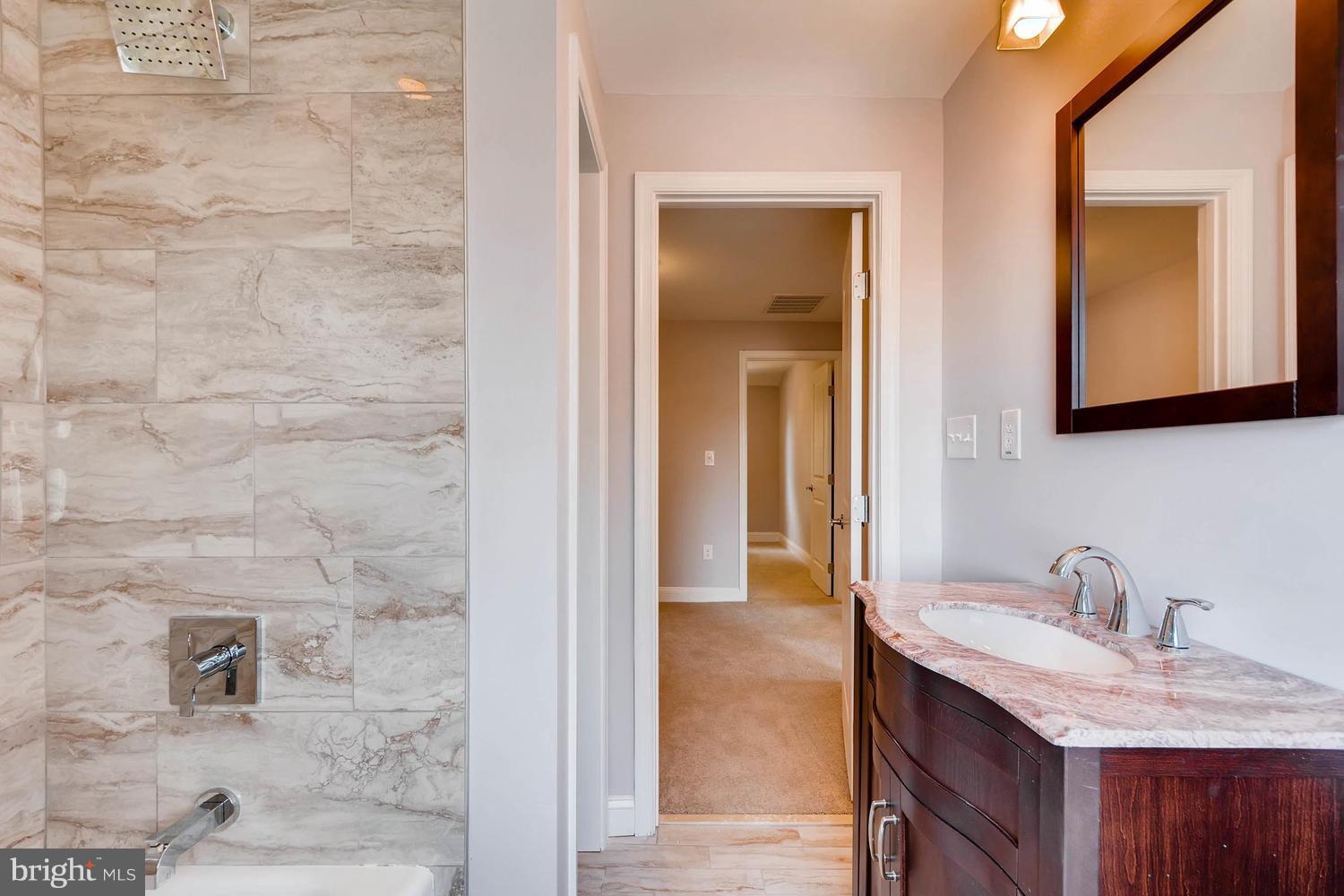 3834 Rexmere Road Baltimore, MD 21218 - Photo 19 of 28 a bathroom with a sink vanity and mirror