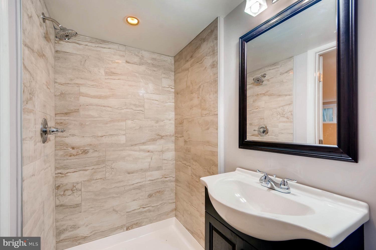 3834 Rexmere Road Baltimore, MD 21218 - Photo 26 of 28 a bathroom with a sink and a mirror