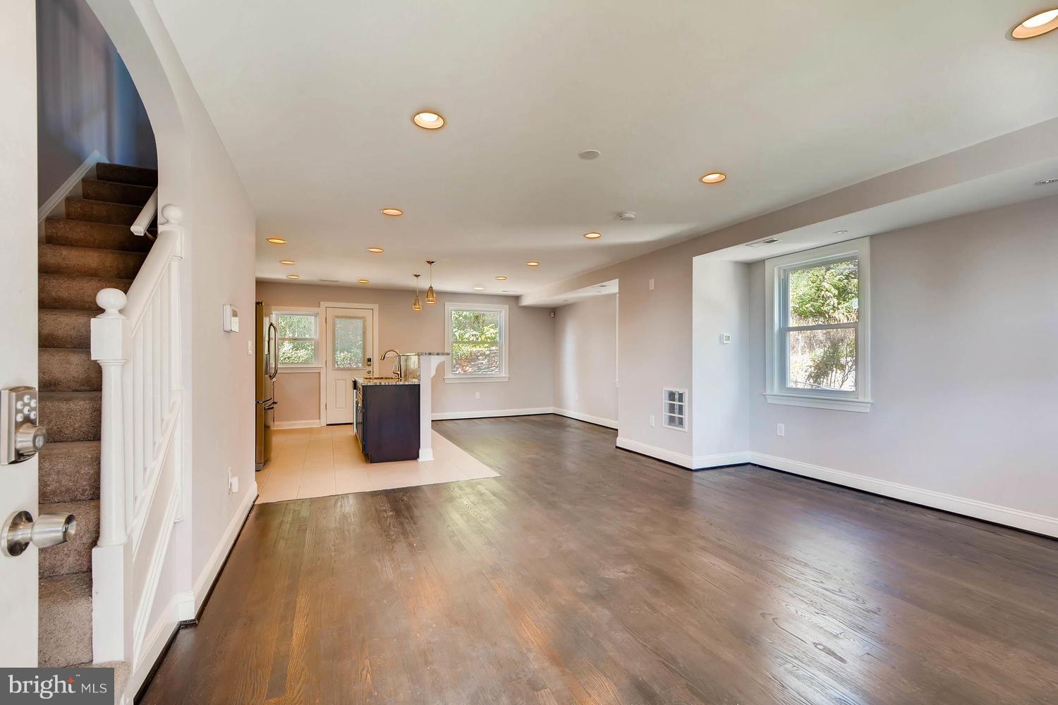 3834 Rexmere Road Baltimore, MD 21218 - Photo 4 of 28 an empty room with wooden floor and windows