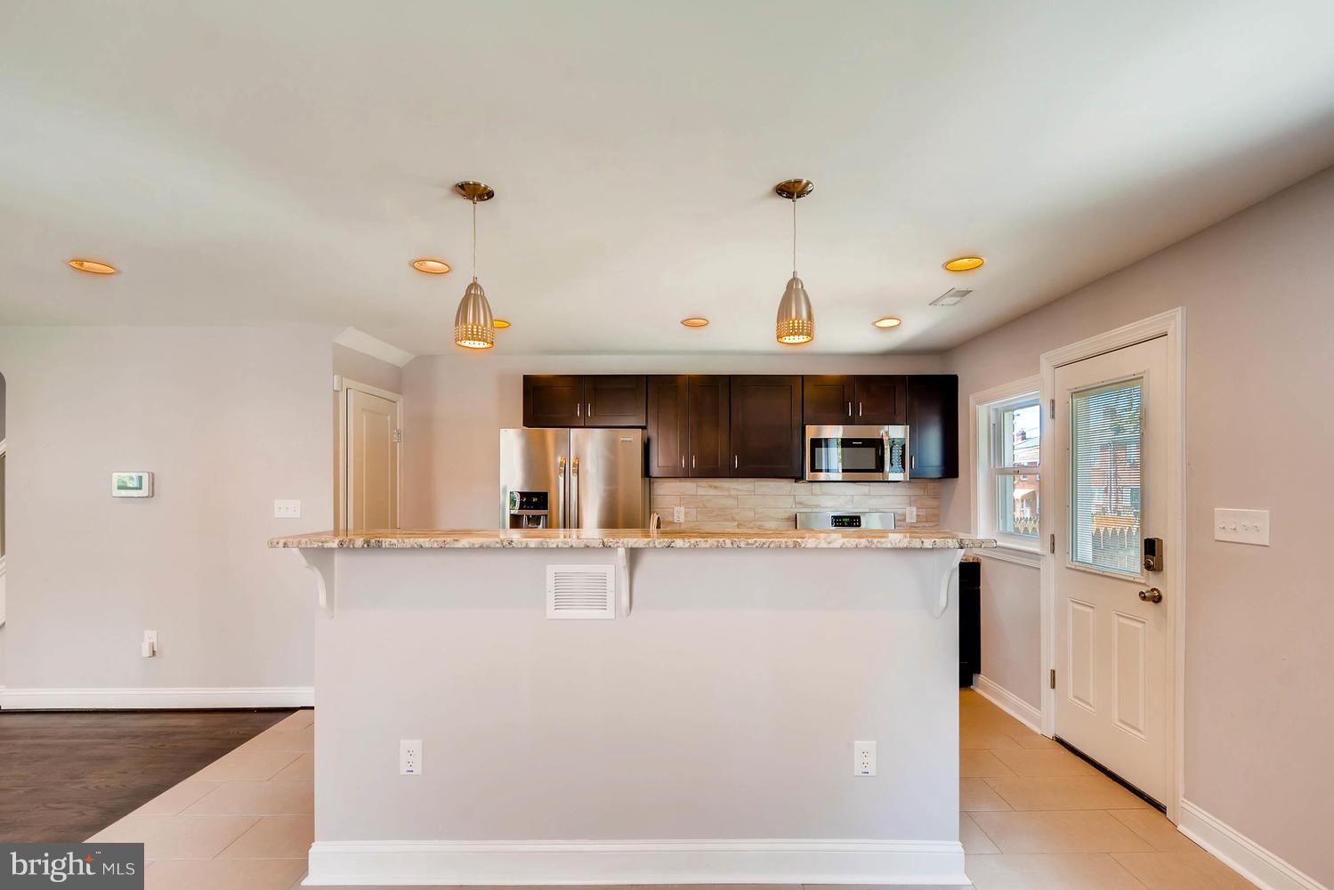 3834 Rexmere Road Baltimore, MD 21218 - Photo 7 of 28 a kitchen with stainless steel appliances a sink and a refrigerator