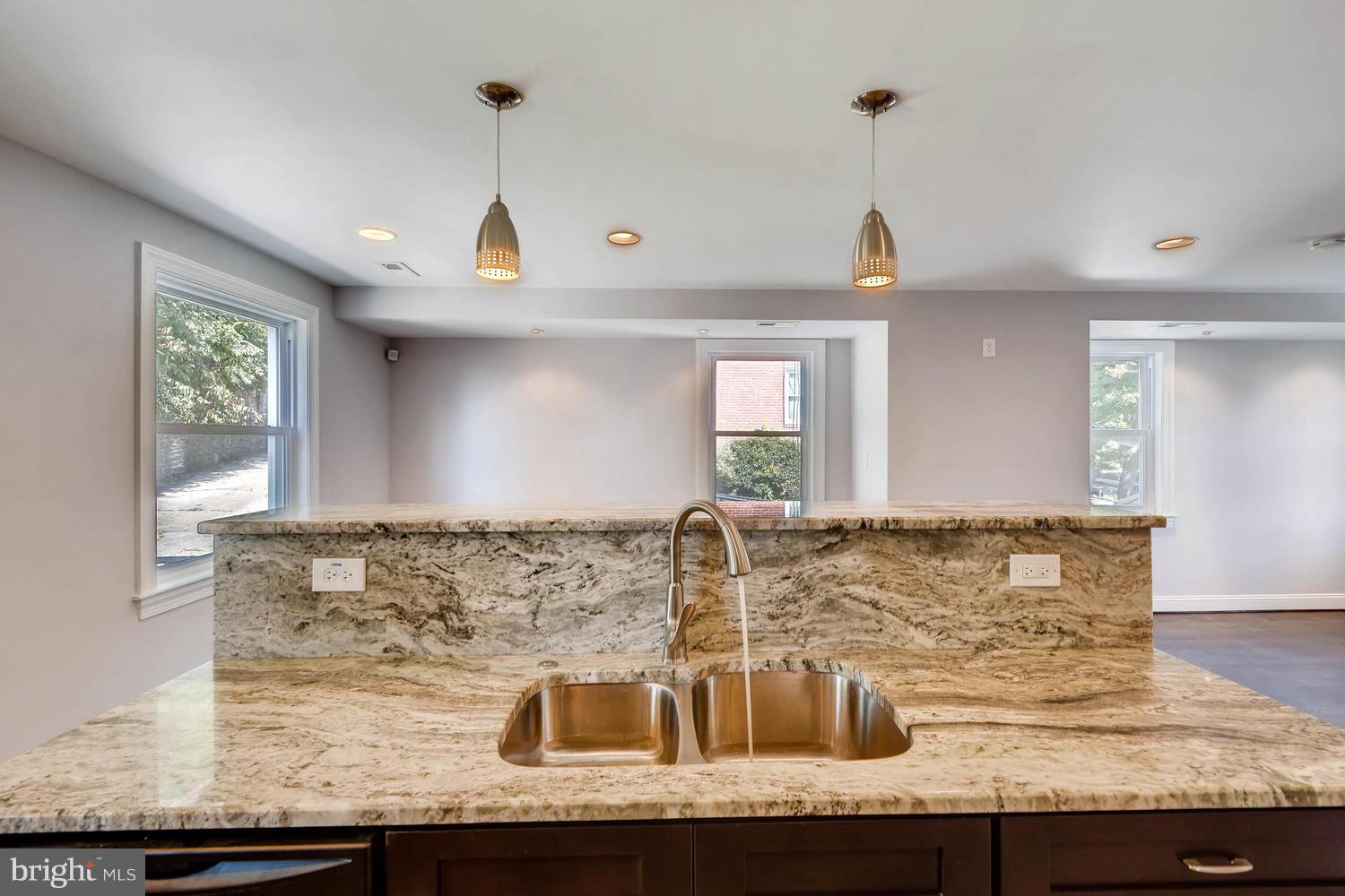 3834 Rexmere Road Baltimore, MD 21218 - Photo 10 of 28 a view of a kitchen with granite countertop a sink stainless steel appliances and cabinets