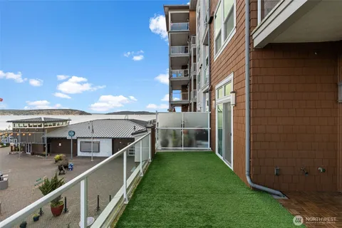 a view of a house with a wooden deck
