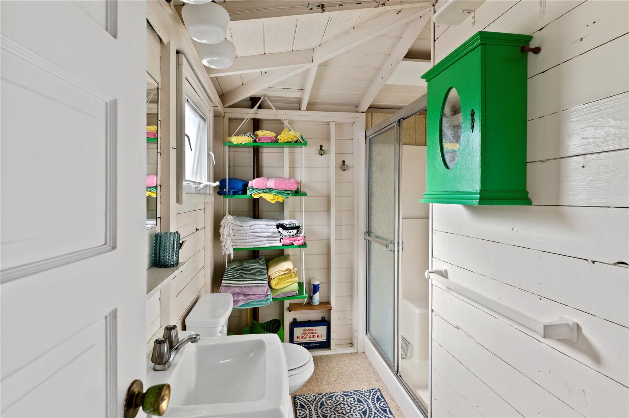 760 Surf Road Ocean Beach, NY 11770 - Photo 13 of 16 Bathroom featuring toilet, sink, wooden ceiling, wooden walls, and a shower with door
