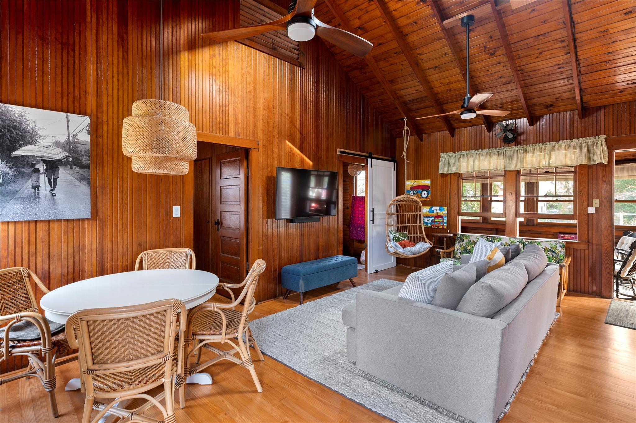 760 Surf Road Ocean Beach, NY 11770 - Photo 14 of 16 Living room featuring beam ceiling, wooden walls, wooden ceiling, and a barn door