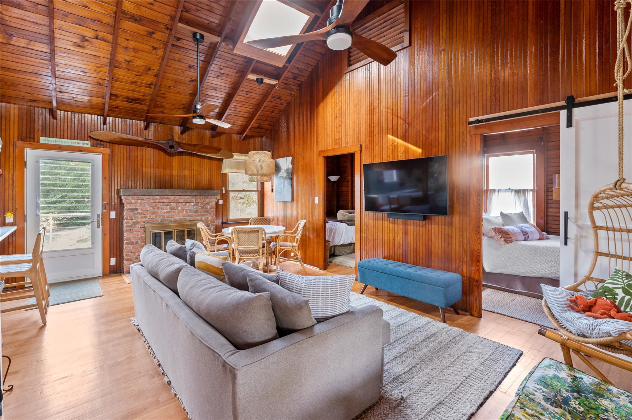 760 Surf Road Ocean Beach, NY 11770 - Photo 15 of 16 Living room with beamed ceiling, a barn door, wooden ceiling, and wood walls