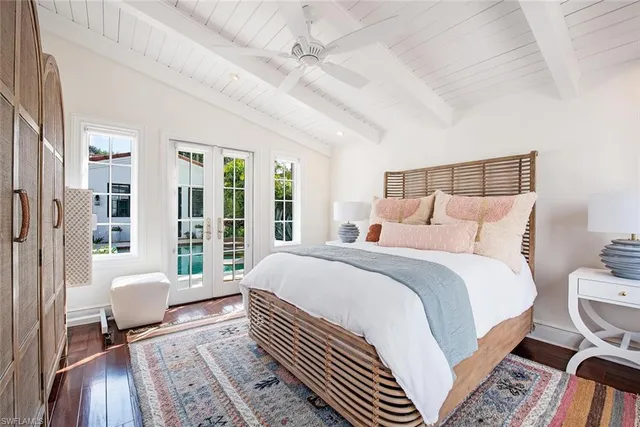 a bedroom with a bed wooden floor and window