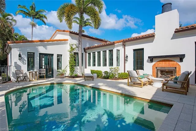 a house view with a seating space and swimming pool