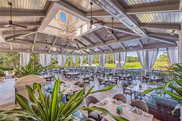 a view of an outdoor dining space with furniture and garden view