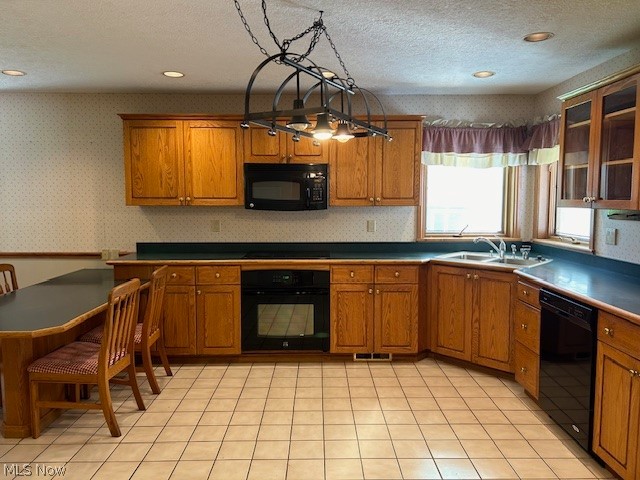 1126 Mudbrook Road Huron, OH 44839 - Photo 5 of 22 Kitchen featuring pendant lighting, black appliances, sink, light tile floors, and a textured ceiling