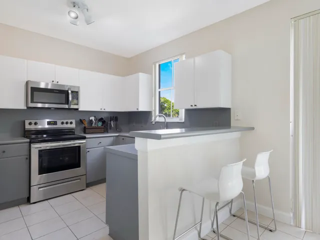 a kitchen with stainless steel appliances a stove a sink and a refrigerator