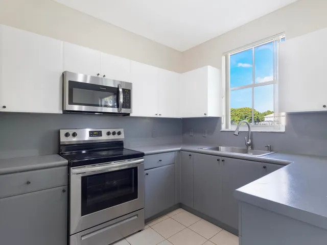 a kitchen with a sink stove and microwave