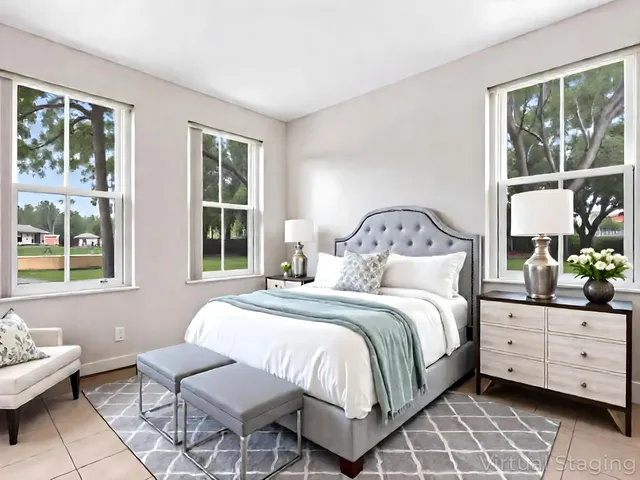 a bedroom with a bed and windows