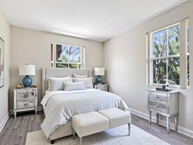 a bedroom with a bed and a large window