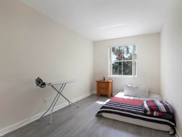 a bedroom with furniture and window