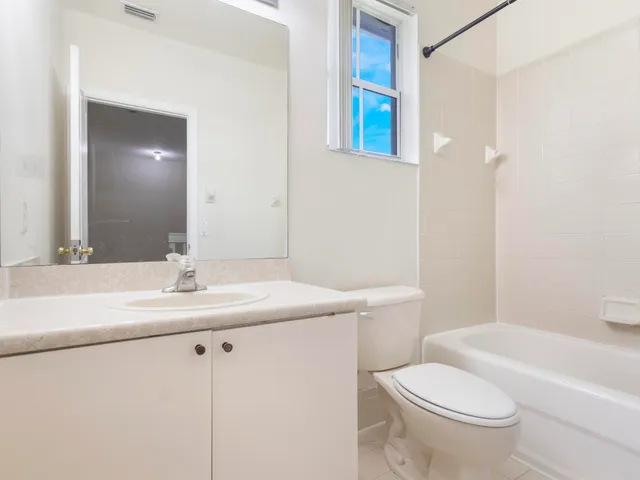 a bathroom with a sink a toilet a mirror and vanity