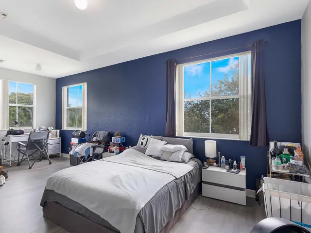 a bedroom with bed and windows