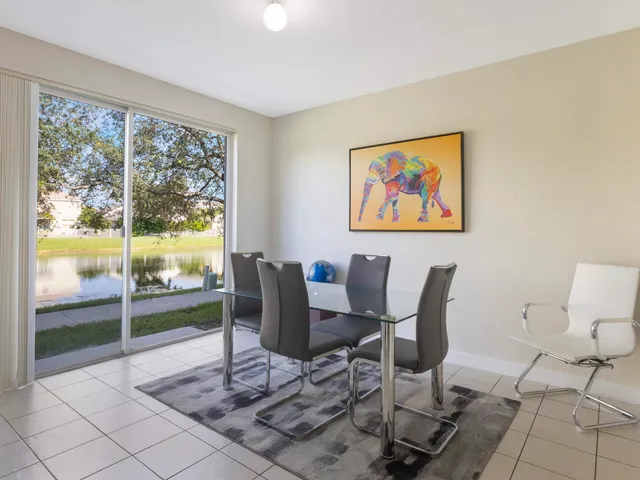 a view of a livingroom with lounge chair and a large window