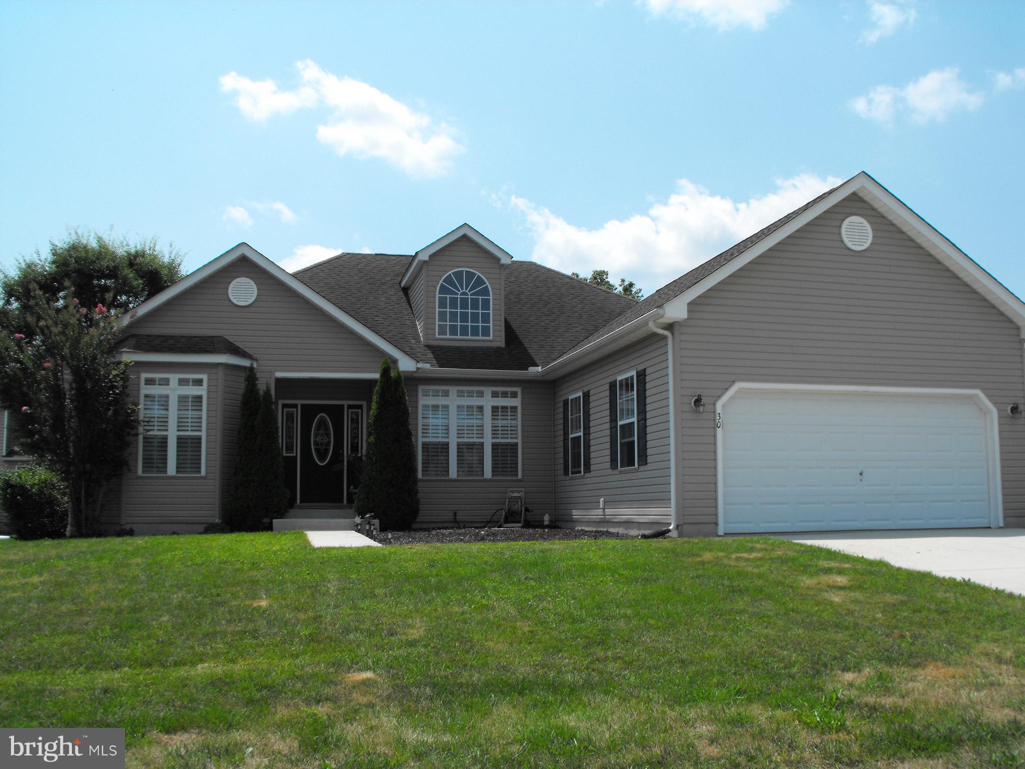 30 Brittingham Drive Dover, DE 19904 - Photo 2 of 36 a front view of a house with a garden and yard