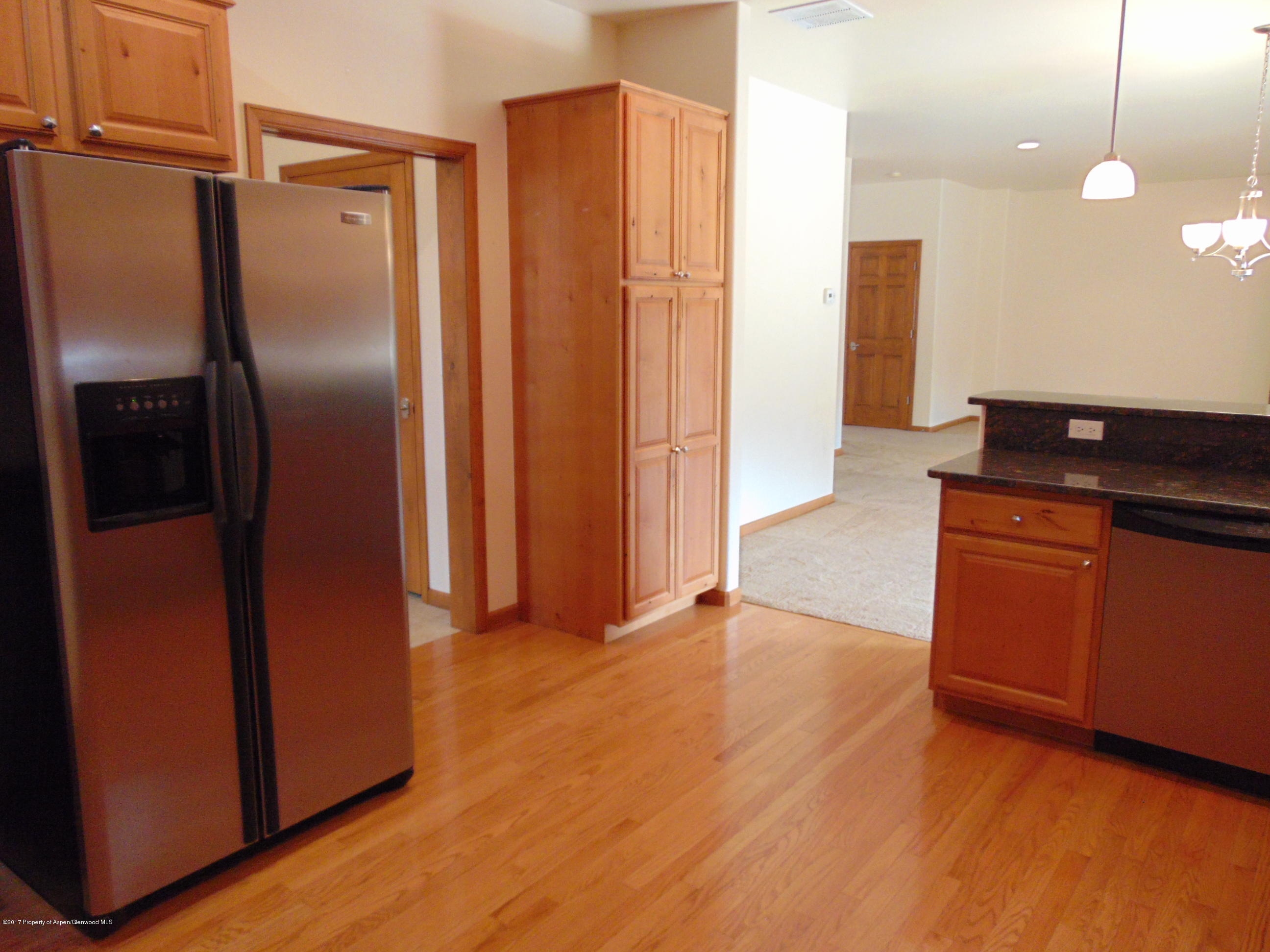 1193 East 19th Street Rifle, CO 81650 - Photo 15 of 40 a kitchen with stainless steel appliances granite countertop a refrigerator and a sink