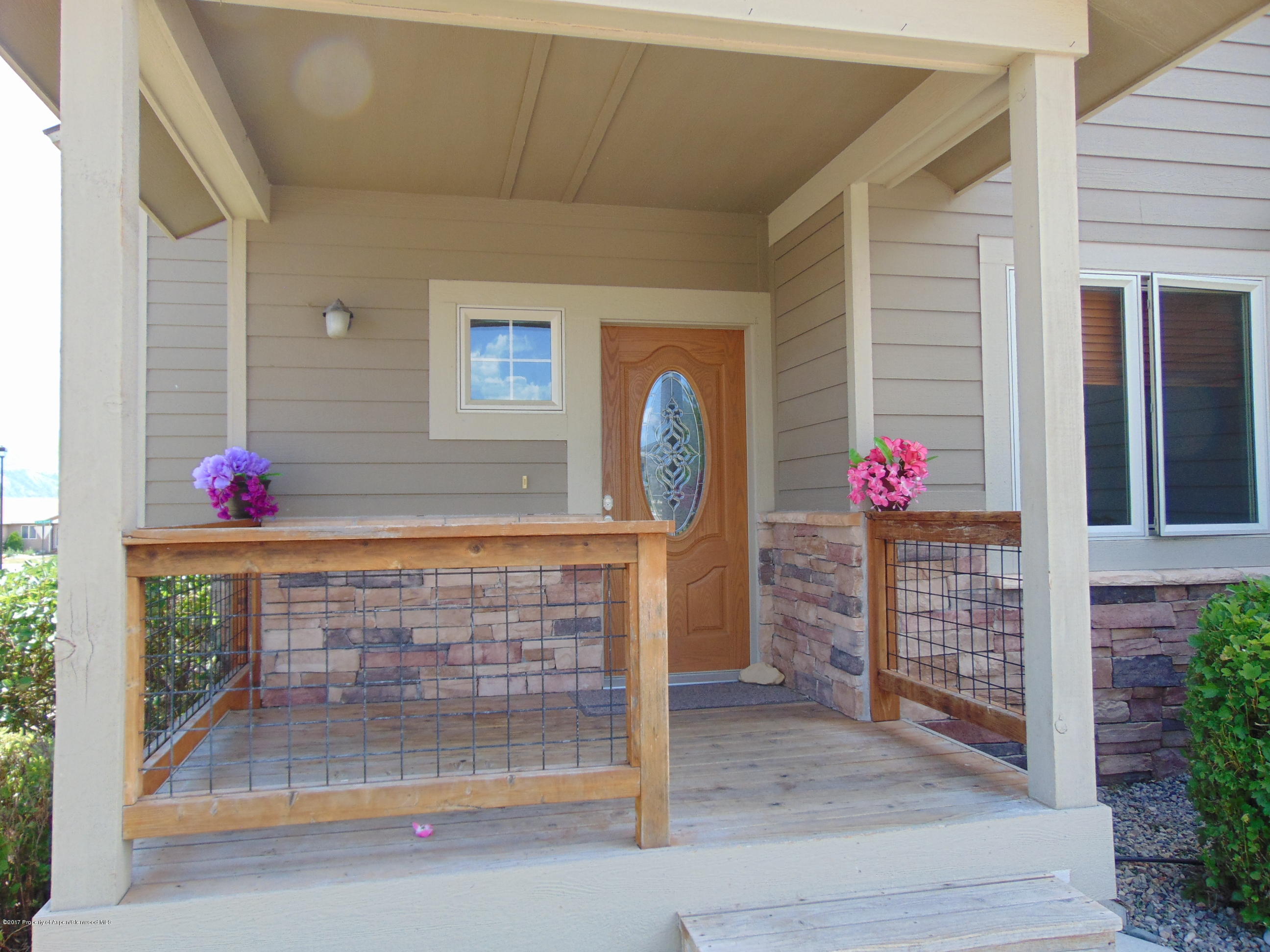 1193 East 19th Street Rifle, CO 81650 - Photo 3 of 40 a front view of a house with flowers