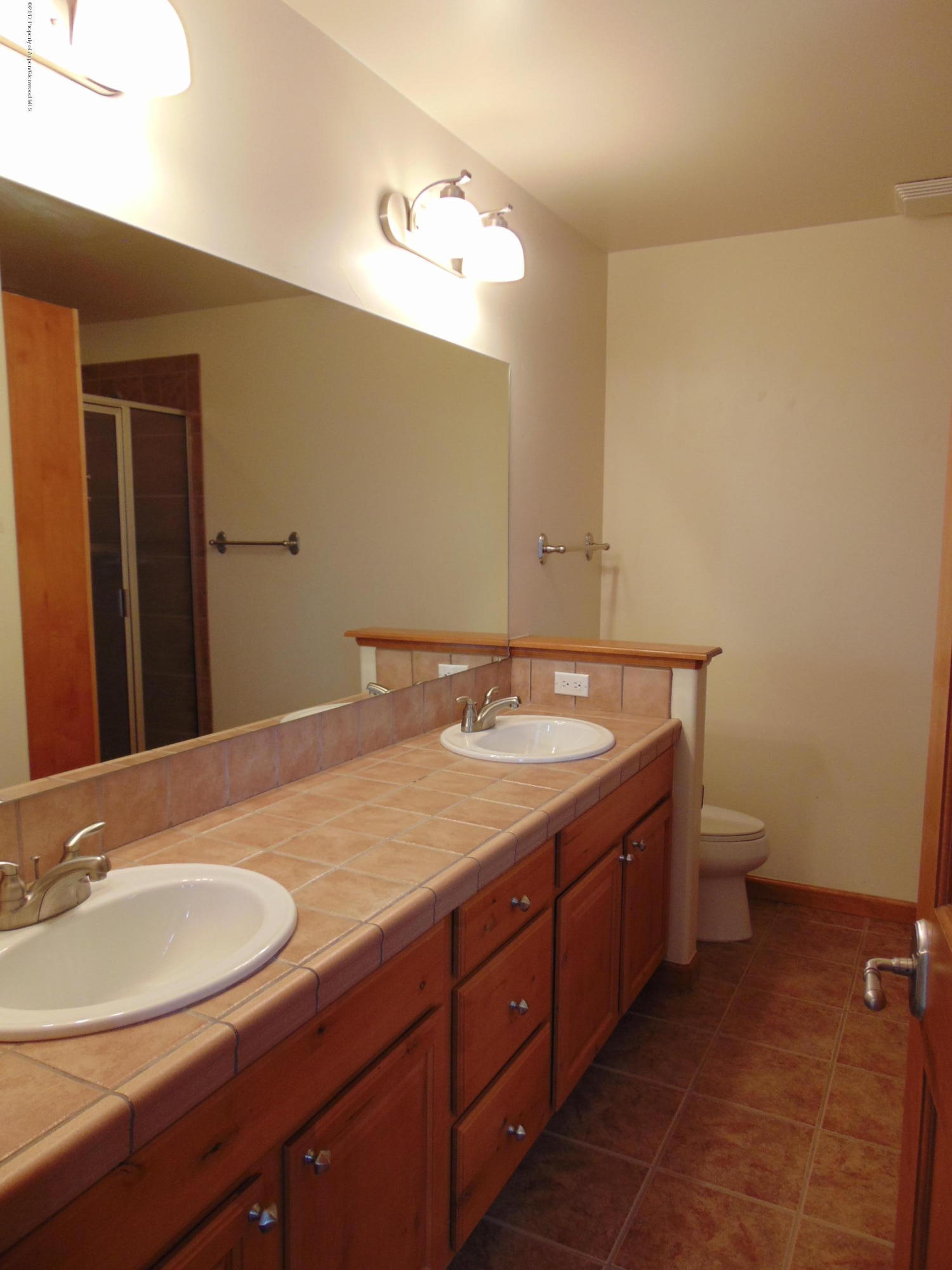 1193 East 19th Street Rifle, CO 81650 - Photo 34 of 40 a bathroom with a granite countertop sink and a mirror