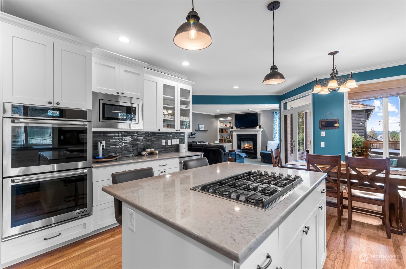 2113 242nd Street Southeast Bothell, WA 98021 - Photo 8 of 38 a kitchen with a stove a microwave and wooden floor