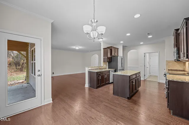 a view of a kitchen with sink microwave and stove