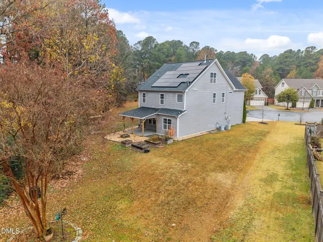 an aerial view of a house with a yard