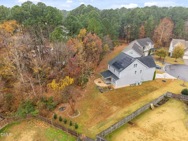 an aerial view of a house with a ocean view