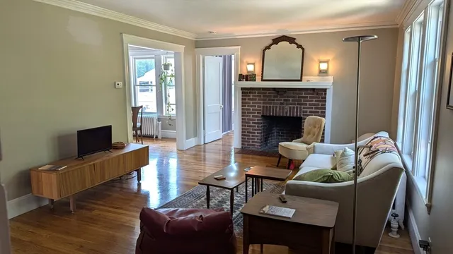 a living room with furniture a fireplace and a flat screen tv