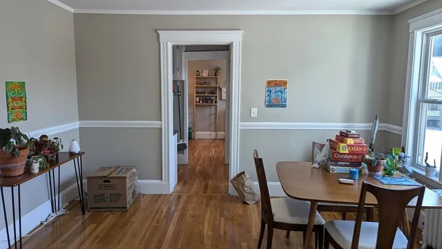 a view of a dining room with furniture and wooden floor