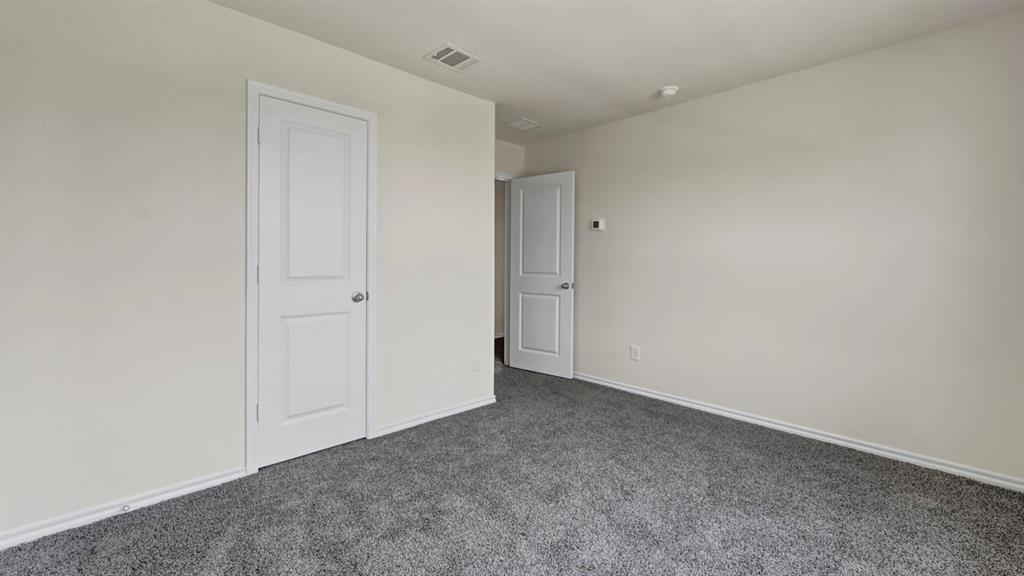 4012 Ripplewood Drive Lindale, TX 75771 - Photo 14 of 37 Spacious room featuring neutral carpeting, light-colored walls, white baseboards, and two-panel interior doors